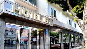 A hotel with a modern facade, large glass windows, and a sign indicating it is a 5-star establishment. - Hotel G (Jeju City)
