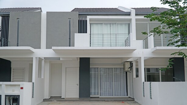A modern multi-story residential building with a central entrance, balconies, and a covered driveway. - CVR Homestay Melaka (Jasin)