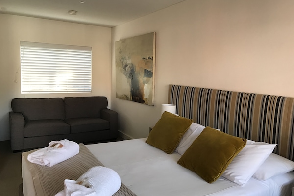 Premium bedding, desk, laptop workspace, iron/ironing board