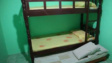 A bunk bed with a floral bedspread and a pillow on the lower bunk.