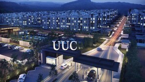 A modern residential area with multiple apartment buildings, a gas station, and a well-lit road. - Quin Homestay (Kota Kinabalu)