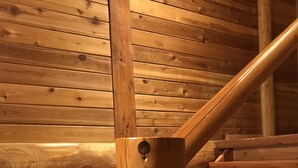 A wooden staircase with a handrail and a wooden wall with horizontal planks. - Mori no Log Hotel Kamloops (Shinano)