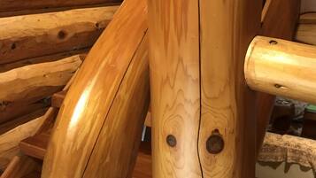 A wooden staircase with a handrail and a wooden wall with horizontal planks.