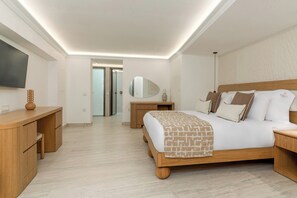 A hotel room with a wooden bed, bedside tables, a TV, and a mirror. - Kallos of Mykonos (Mykonos)