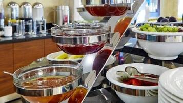 A buffet setup with various food items and beverages.
