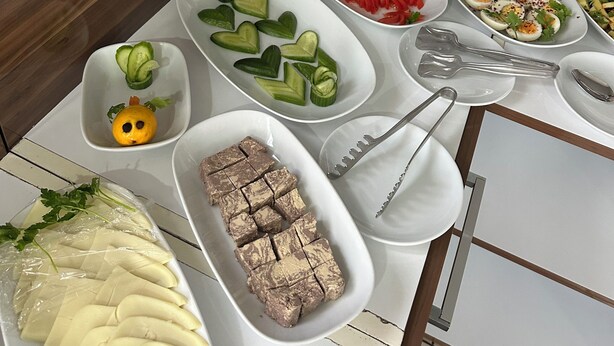 A buffet table with various food items including fruits, vegetables, and prepared dishes. - Kosk Hotel (Elazig)