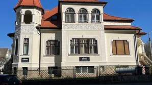 A two-story building with a red-tiled roof, a tower with a conical roof, and a sign reading "SOPHIA". - Vila Marioara (Sibiu)