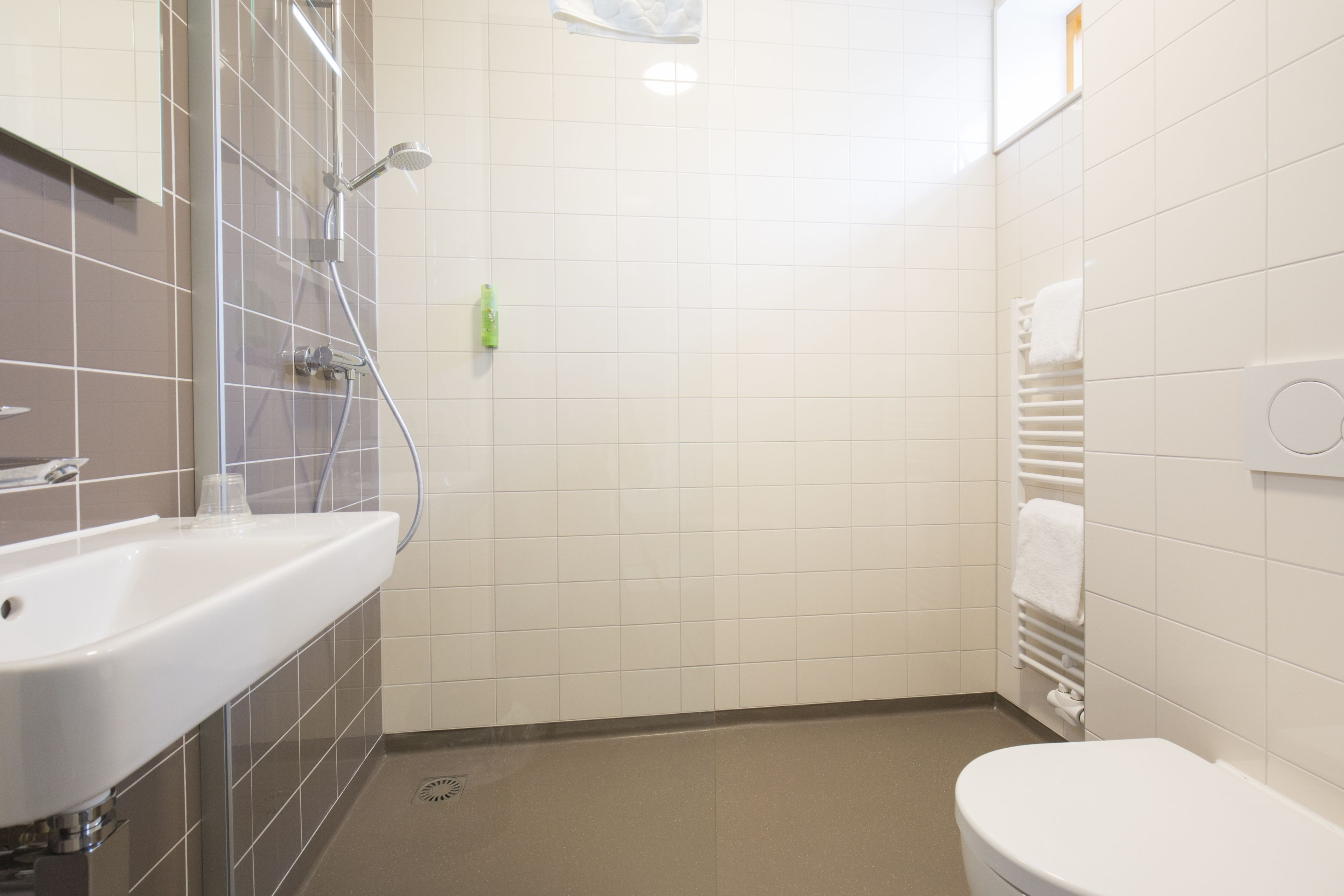 A bathroom with a sink, toilet, and shower.