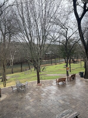 A park with benches, a swing set, and a picnic table.