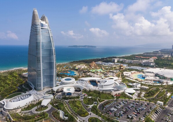 A modern hotel complex with a prominent tower, multiple swimming pools, and a marina. - Atlantis Sanya (Sanya)