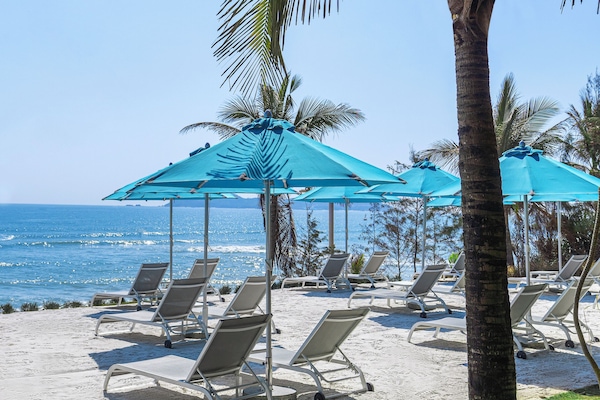 On the beach, sun loungers, beach umbrellas, beach towels
