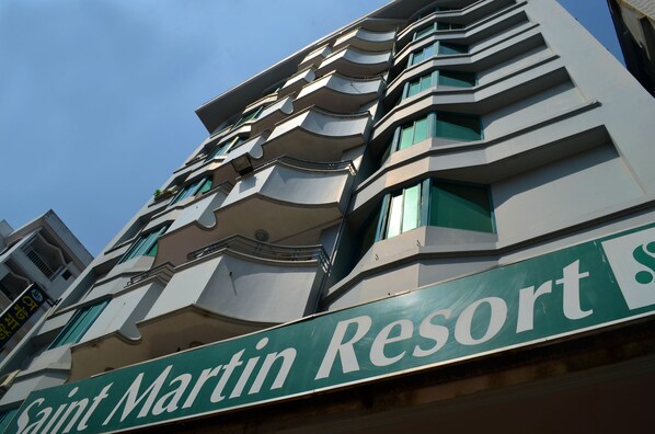 A multi-story building with a sign reading "Saint Martin Resort".