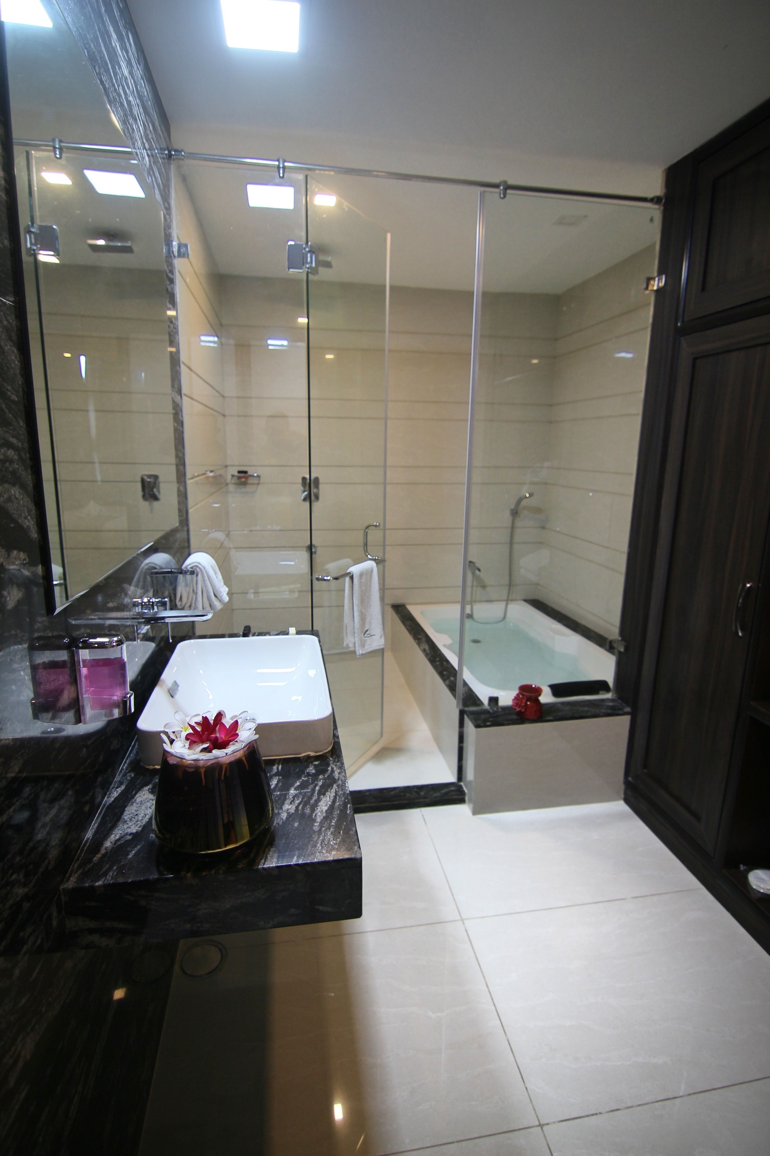 pool view suite with bathtub | bathroom | deep-soaking bathtub, rainfall showerhead, free toiletries, hair dryer