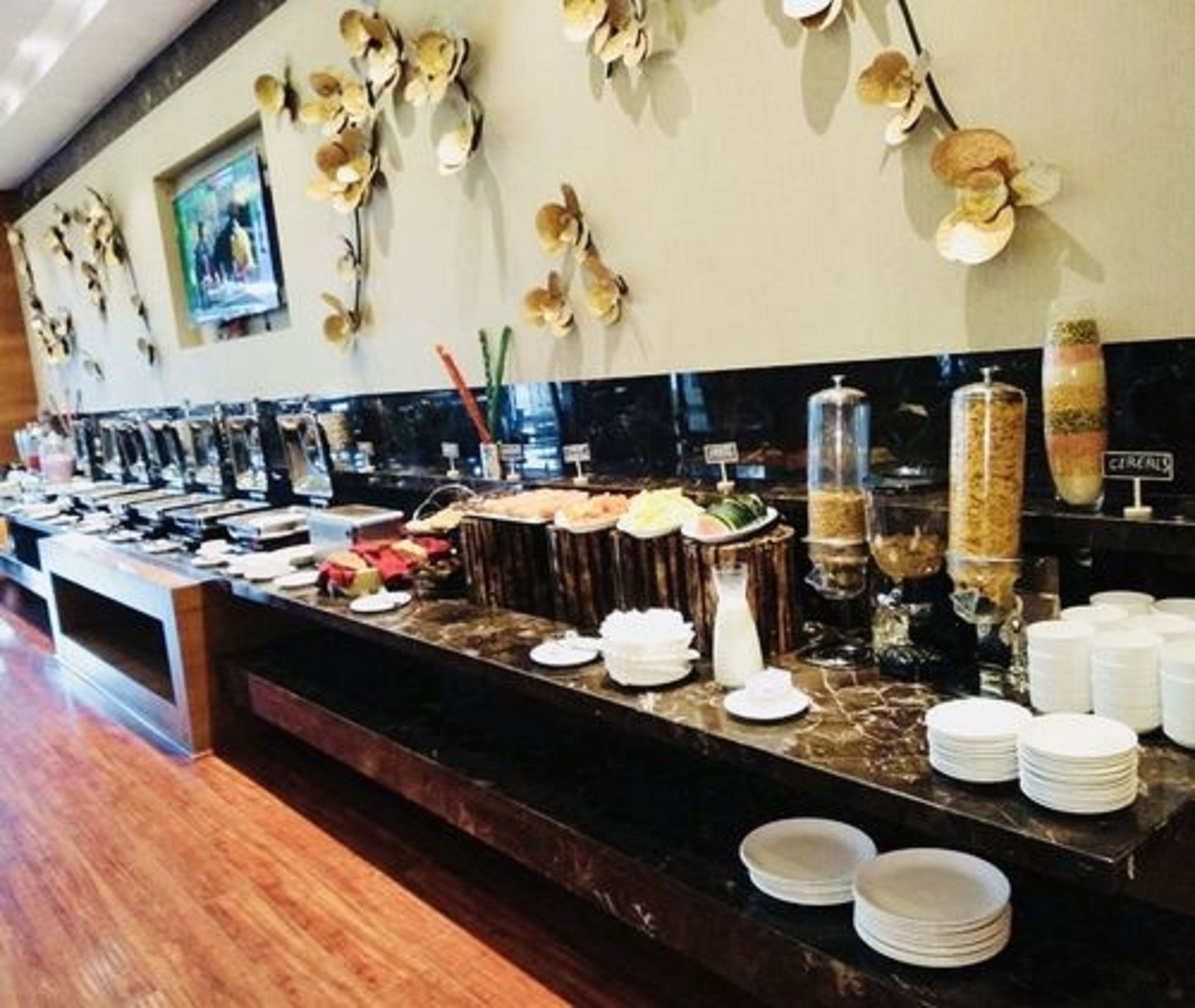 A buffet setup with various food items and condiments.