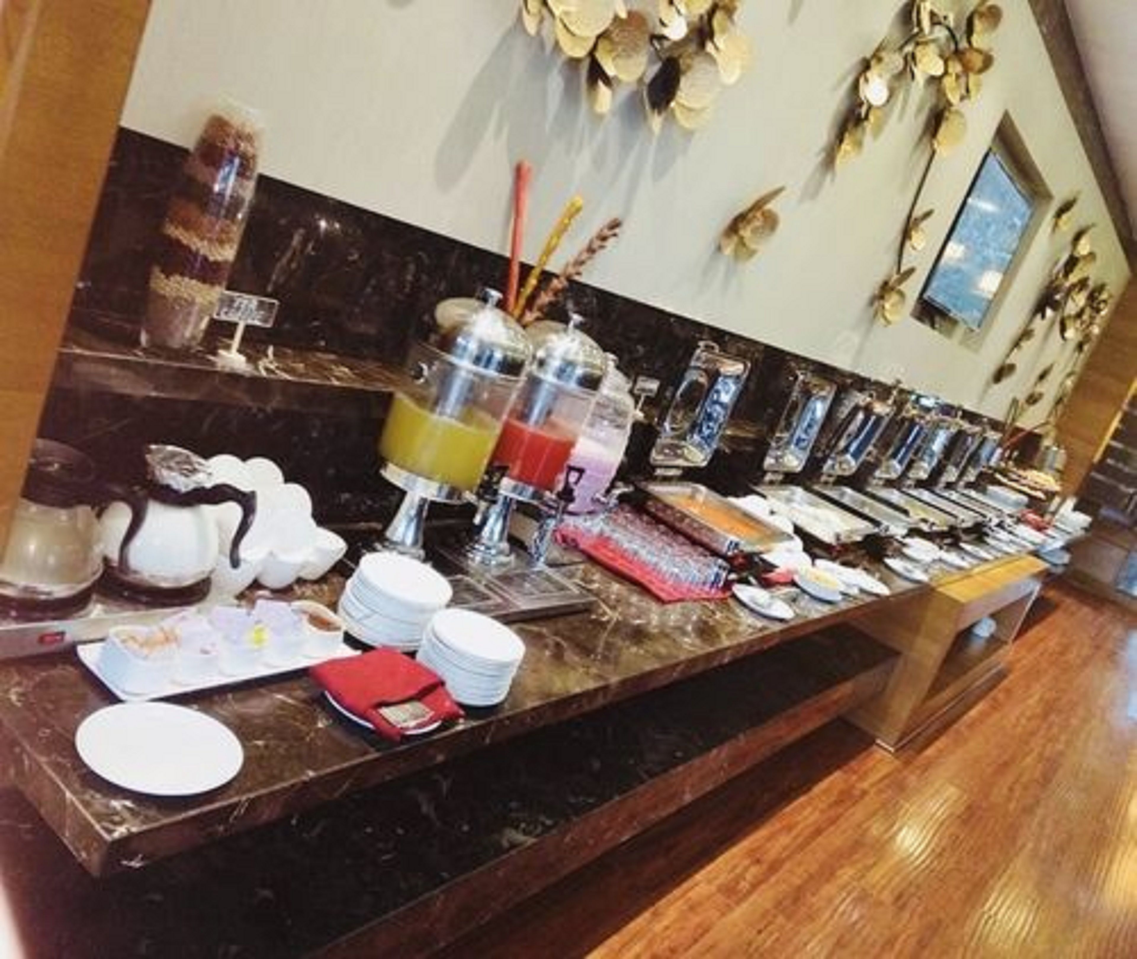 A buffet setup with various food items and beverages.