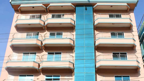 A multi-story building with balconies, a sign for Albatross Resort, and a parked van in front. - Albatross Resort (Cox's Bazar)