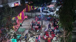 An outdoor market area with various stalls and tables set up for dining, surrounded by trees and plants. - Hotel Peace Palace (Baglung)
