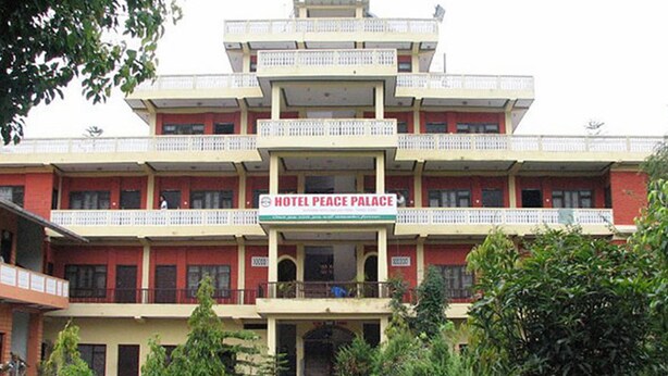 A multi-story building with a sign reading "Hotel Peace Palace." - Hotel Peace Palace (Baglung)