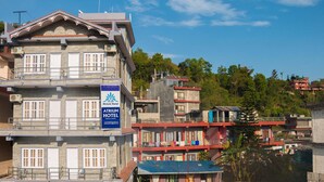 A multi-story building with a sign for Atrium Hotel. - Hotel Atrium (Pokhara)