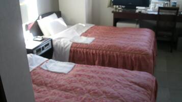 A hotel room with two beds, a desk, a chair, and a television.