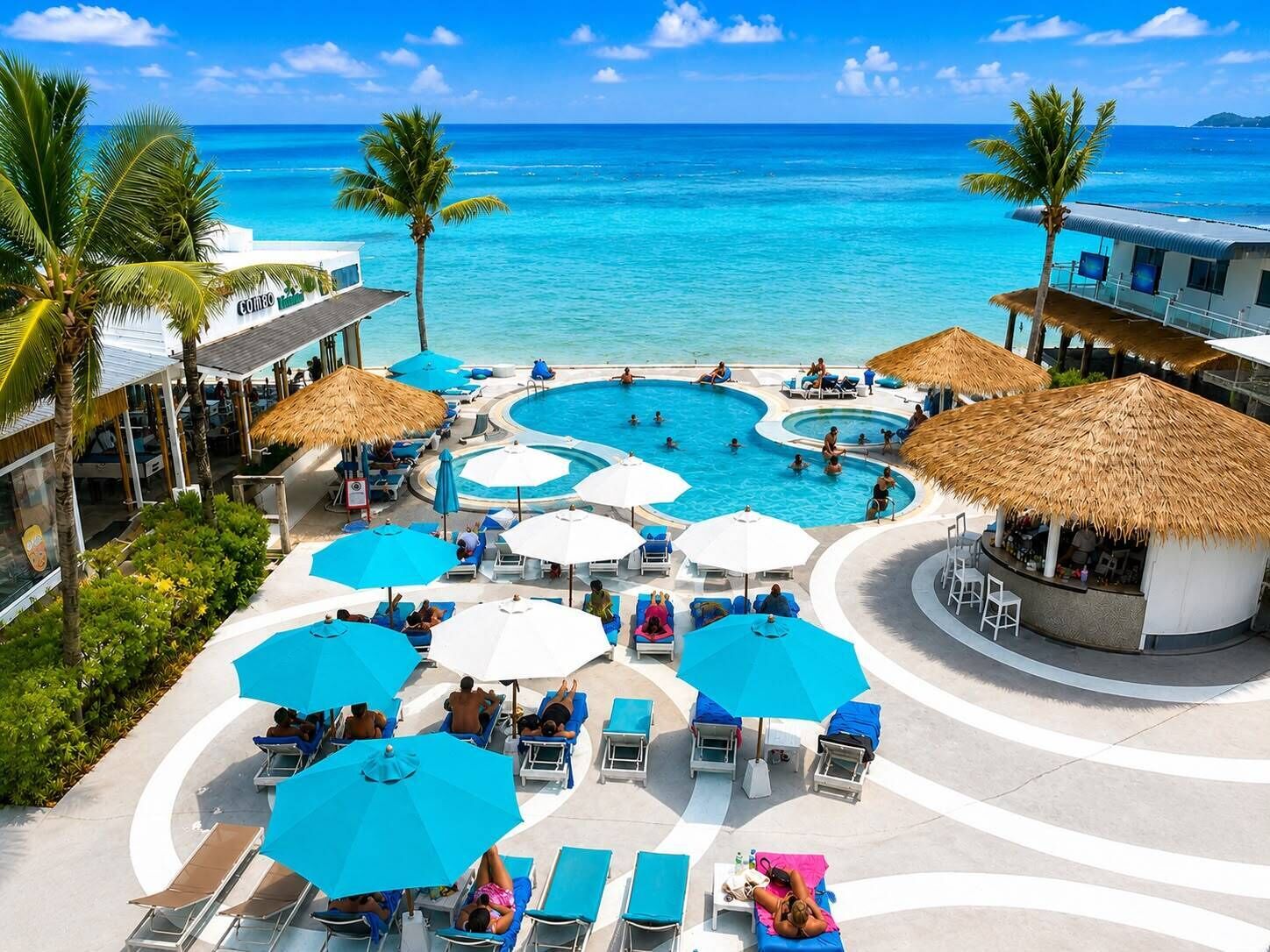 A resort with a central pool area, multiple lounge chairs, and umbrellas.