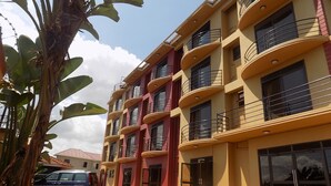 A multi-story building with balconies and large windows. - Olina Hotel and Apartments (Kampala)
