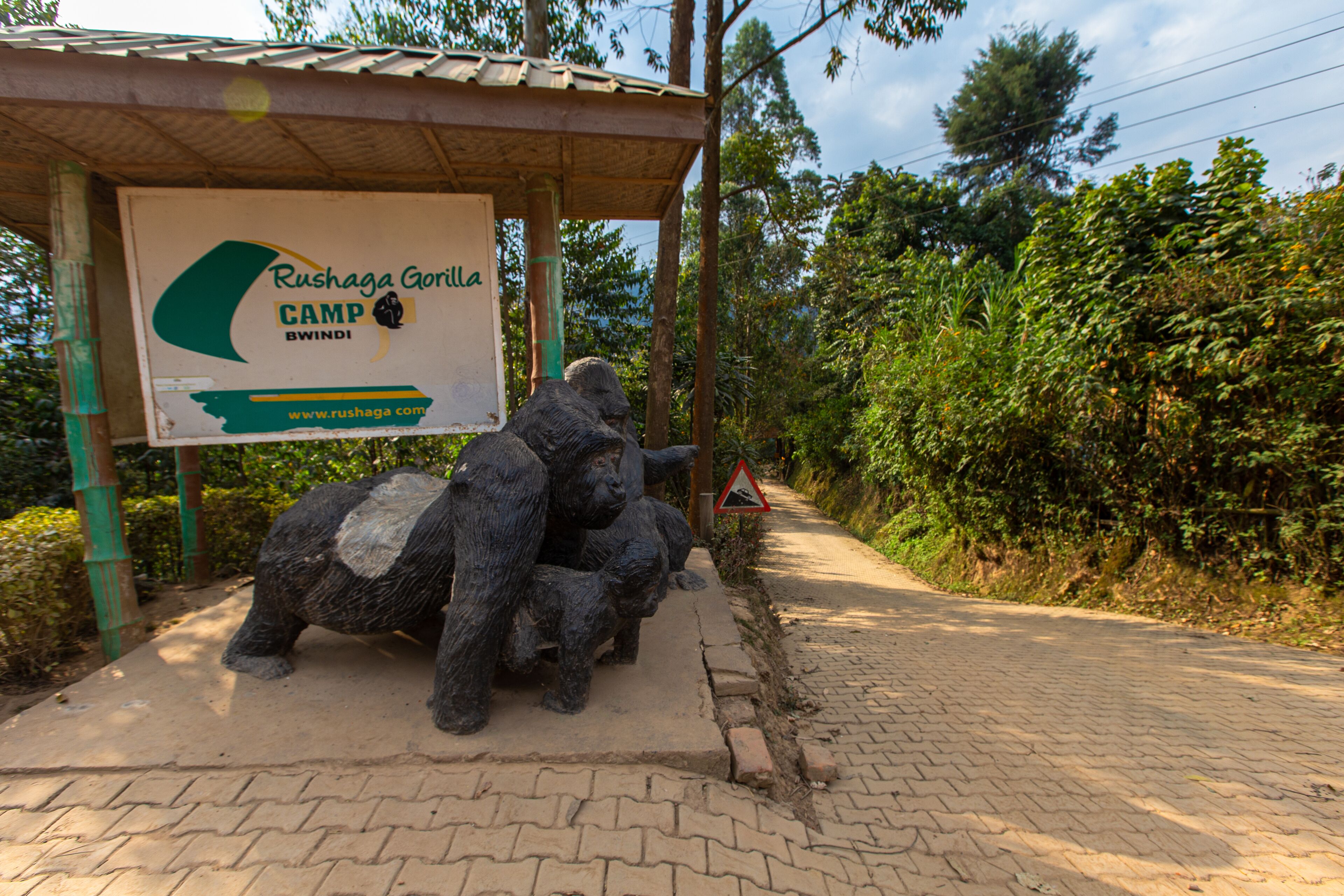 A sign for Rushaga Gorilla Camp with a pathway leading to it.