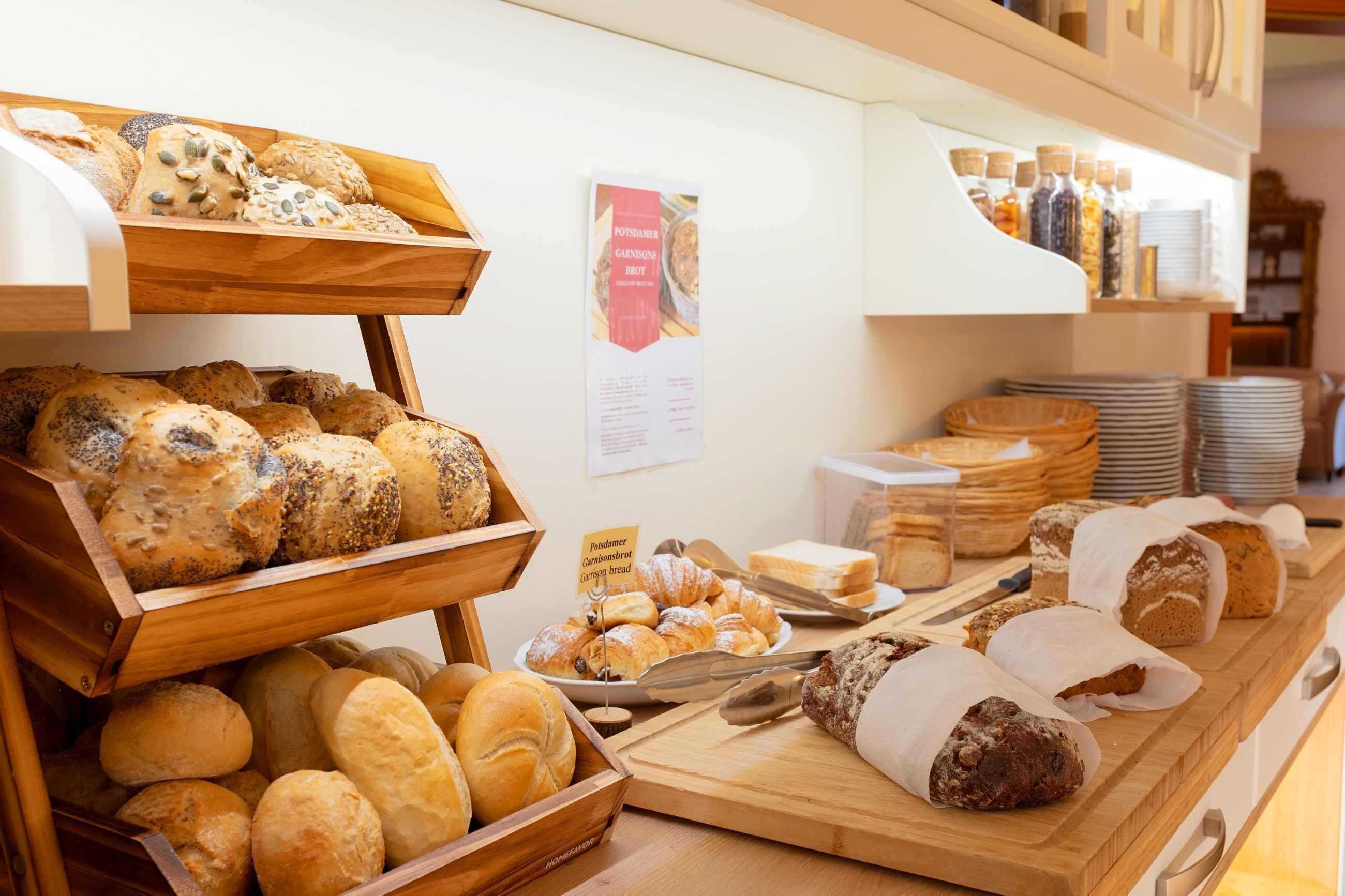 A bakery display with various breads and pastries.