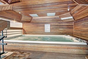 A wooden spa room with a hot tub, wooden walls, and a caution sign. - VS436H Village Square Studio Bedroom 1Bathroom Hotel Room (Copper Mountain)