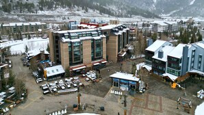 A multi-story hotel with a central courtyard, surrounded by snow-covered mountains. - Perfectly Located Hotel Room, Steps to American Eagle chair - Ski-In Ski-Out Property - MP518H by RedAwning (Copper Mountain)
