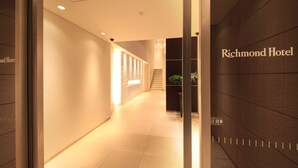 A hallway with a sign reading "Richmond Hotel" and a staircase in the background.