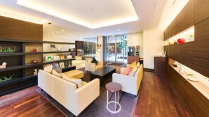 A modern interior with a sofa, coffee table, and shelves.