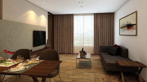 A modern hotel room with a dining area, a sofa, a TV, and a large window with curtains. - Sayaji Vadodara (Vadodara)
