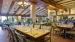 A spacious dining area with high ceilings, chandeliers, and large windows offering a view of the outdoors. - Berjaya Hills Golf & Country Club (Bukit Tinggi)
