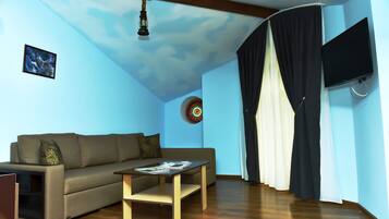 Family Suite, Multiple Beds | Living area | 81-cm LCD TV with satellite channels, TV