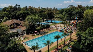 A pool area with multiple swimming pools, a water slide, and lounge chairs. - Marina Hotel Club (Cogolin)