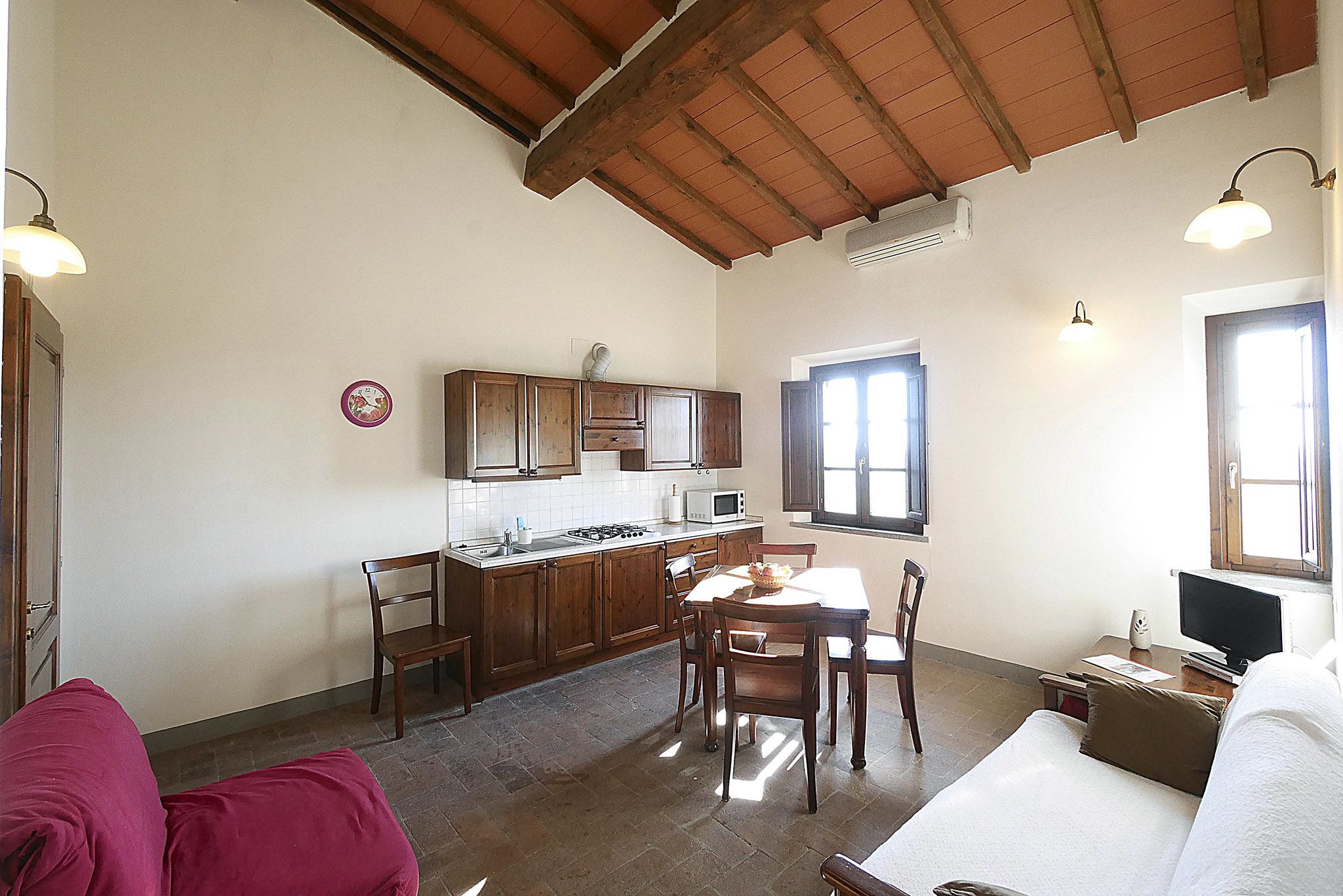 A compact living space with a kitchen, dining area, and a small seating area.
