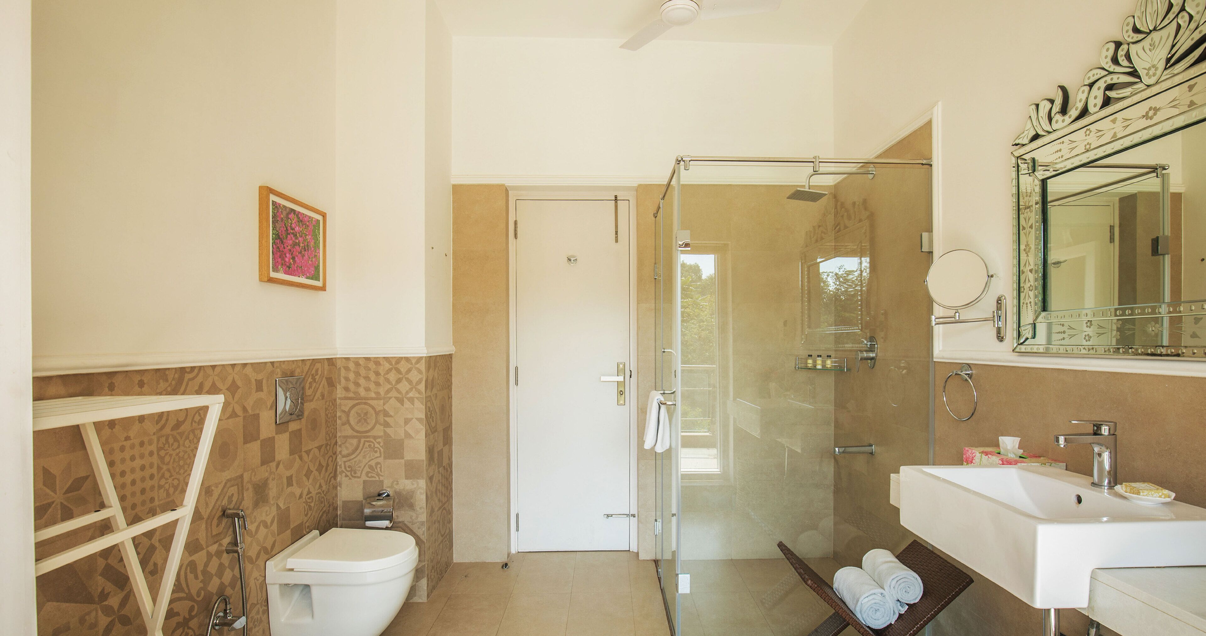 A bathroom with a shower, toilet, and sink.