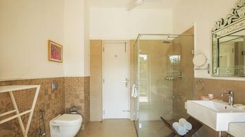 A bathroom with a shower, toilet, and sink.