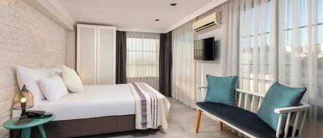 A modern bedroom with a bed, bedside table, and a bench.