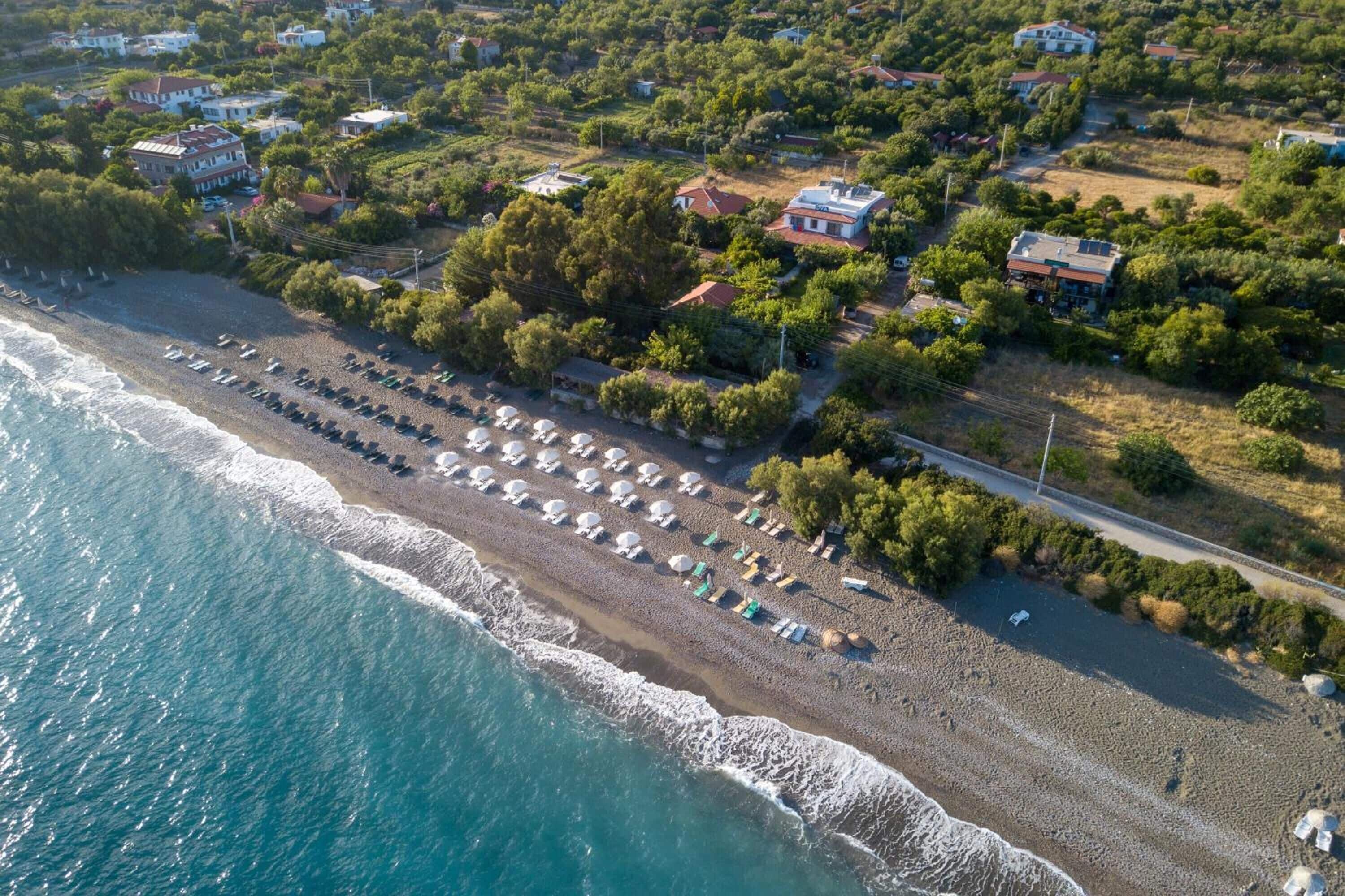 private beach, black sand, sun-loungers, beach umbrellas