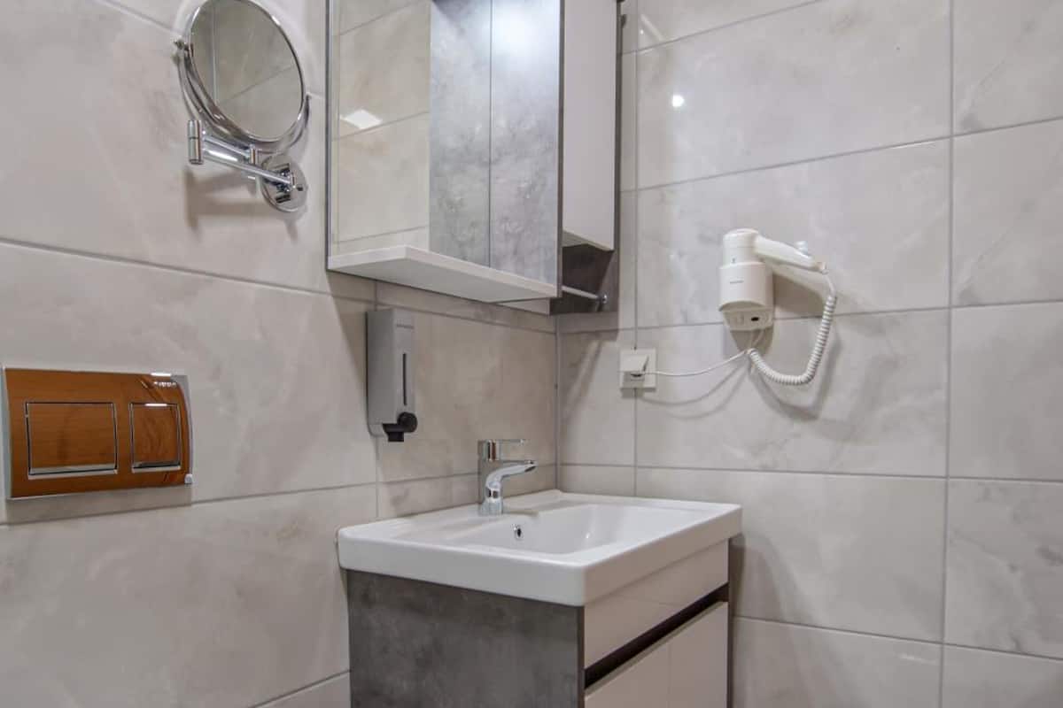 shower, hair dryer, slippers, towels