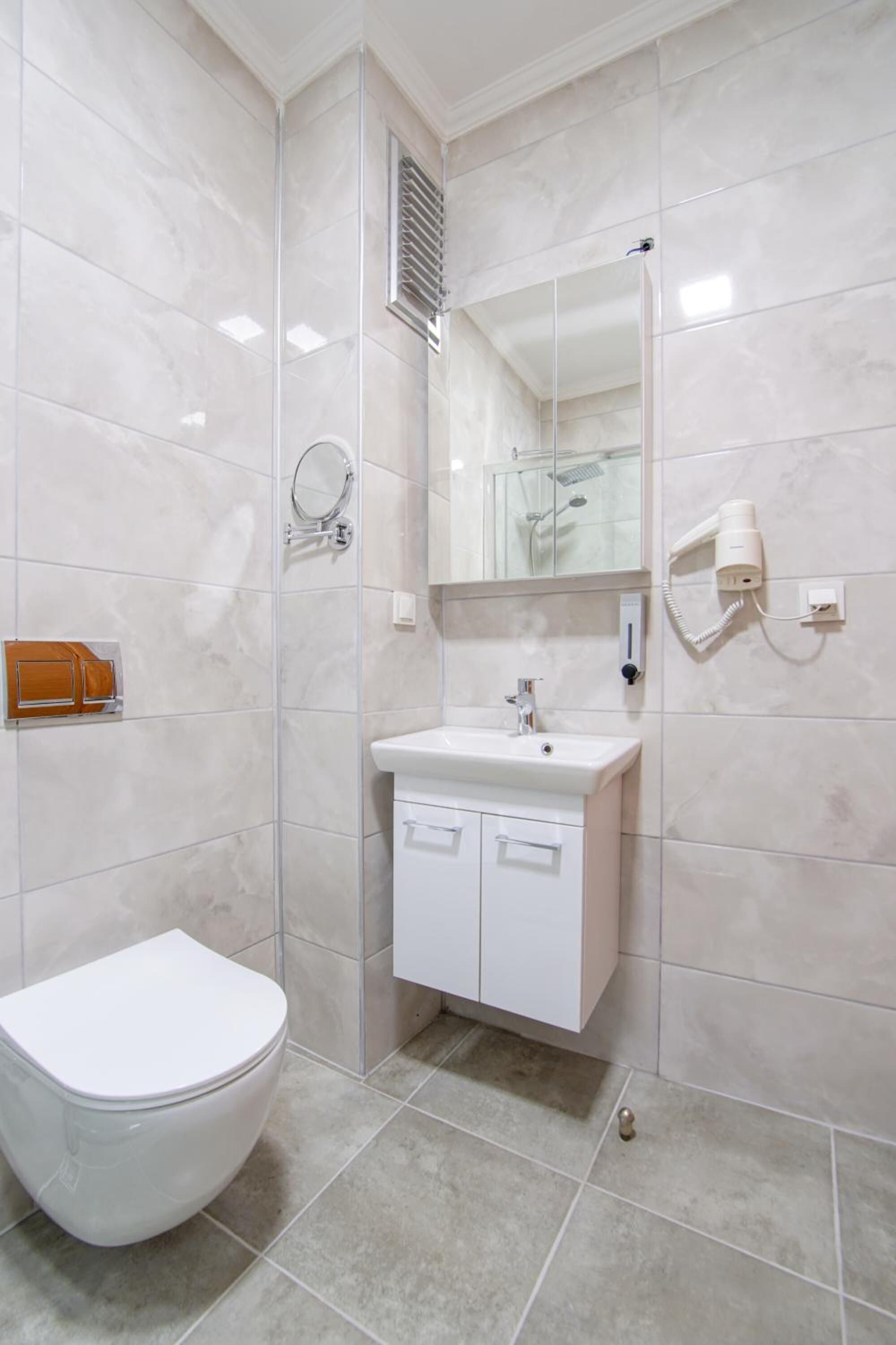 shower, hair dryer, slippers, towels