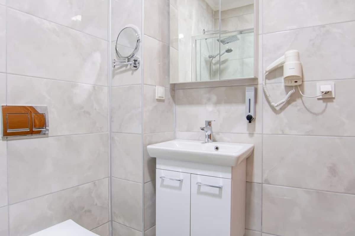 shower, hair dryer, slippers, towels