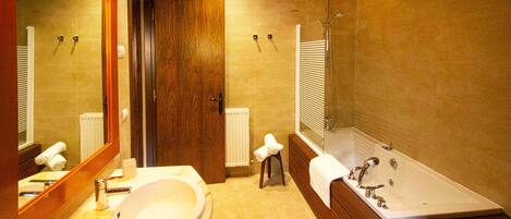 A bathroom with a sink, mirror, towel rack, and a bathtub.