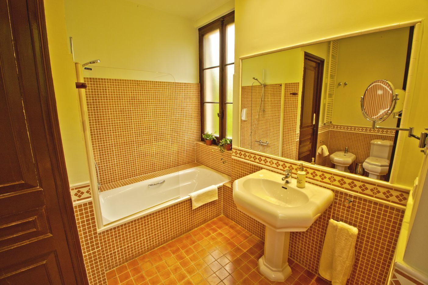Un baño con bañera, lavabo e inodoro.