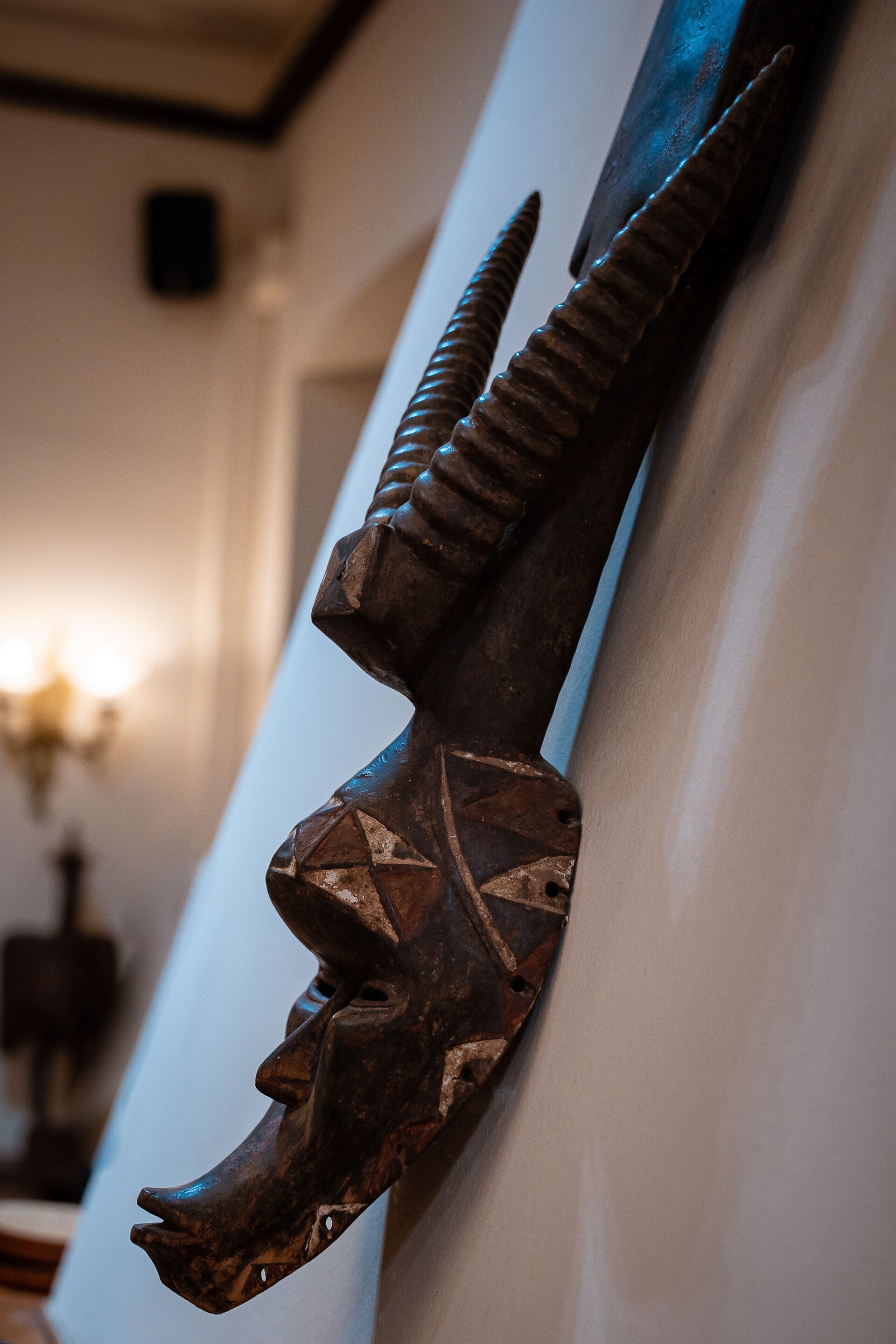A wall-mounted sculpture with a horn-like structure.