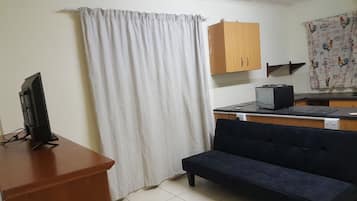 Apartment, 1 Bedroom | Living area | Flat-screen TV