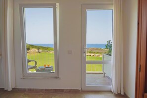 Quarto casal luxo, sacada, vista para o mar | Frigobar, Wi-Fi de cortesia, roupa de cama