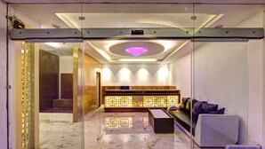 A reception area with a marble floor, a reception desk, and a seating area with a sofa and chairs. - Hill County Resort & Spa, Manali (Manali)
